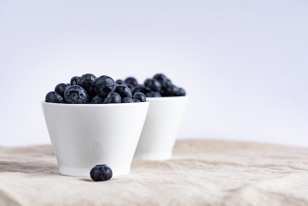 two bowls of fresh blueberries