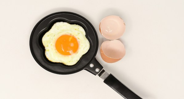A fried egg in a small frying pan